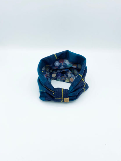 Blue fabric tube with colorful interior on a white background