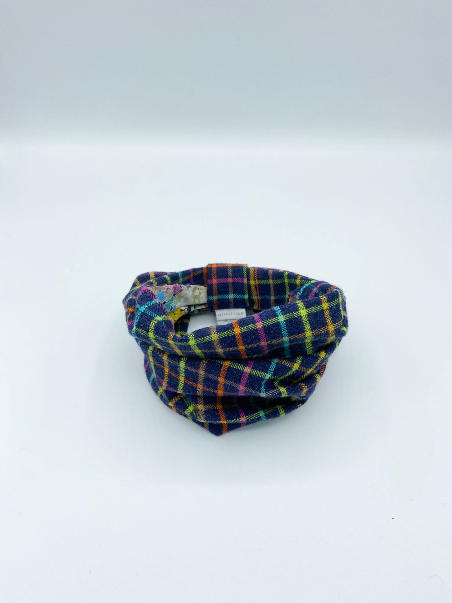 Plaid patterned fabric tube on a white background