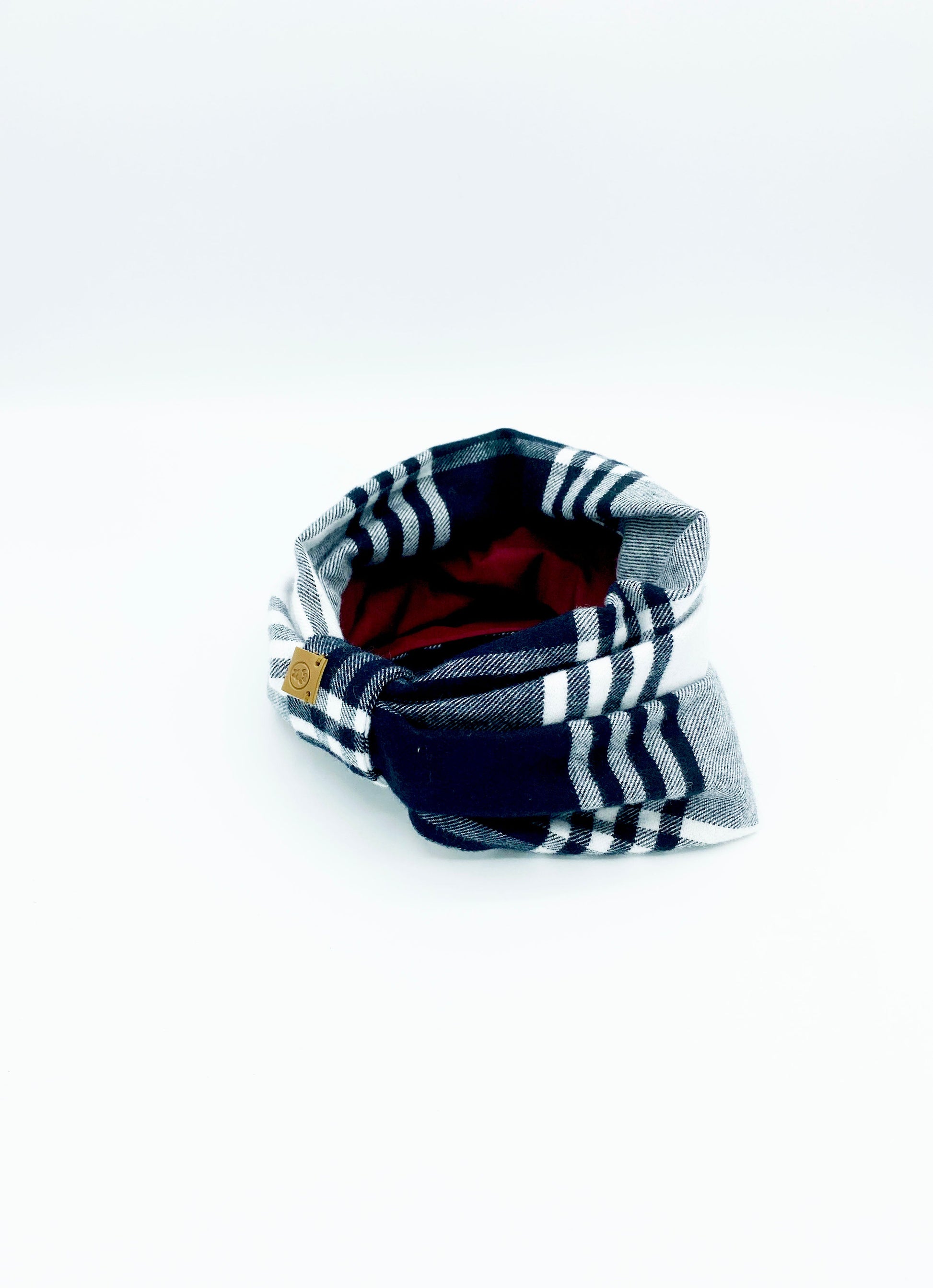 Plaid dog collar with red interior on a white background
