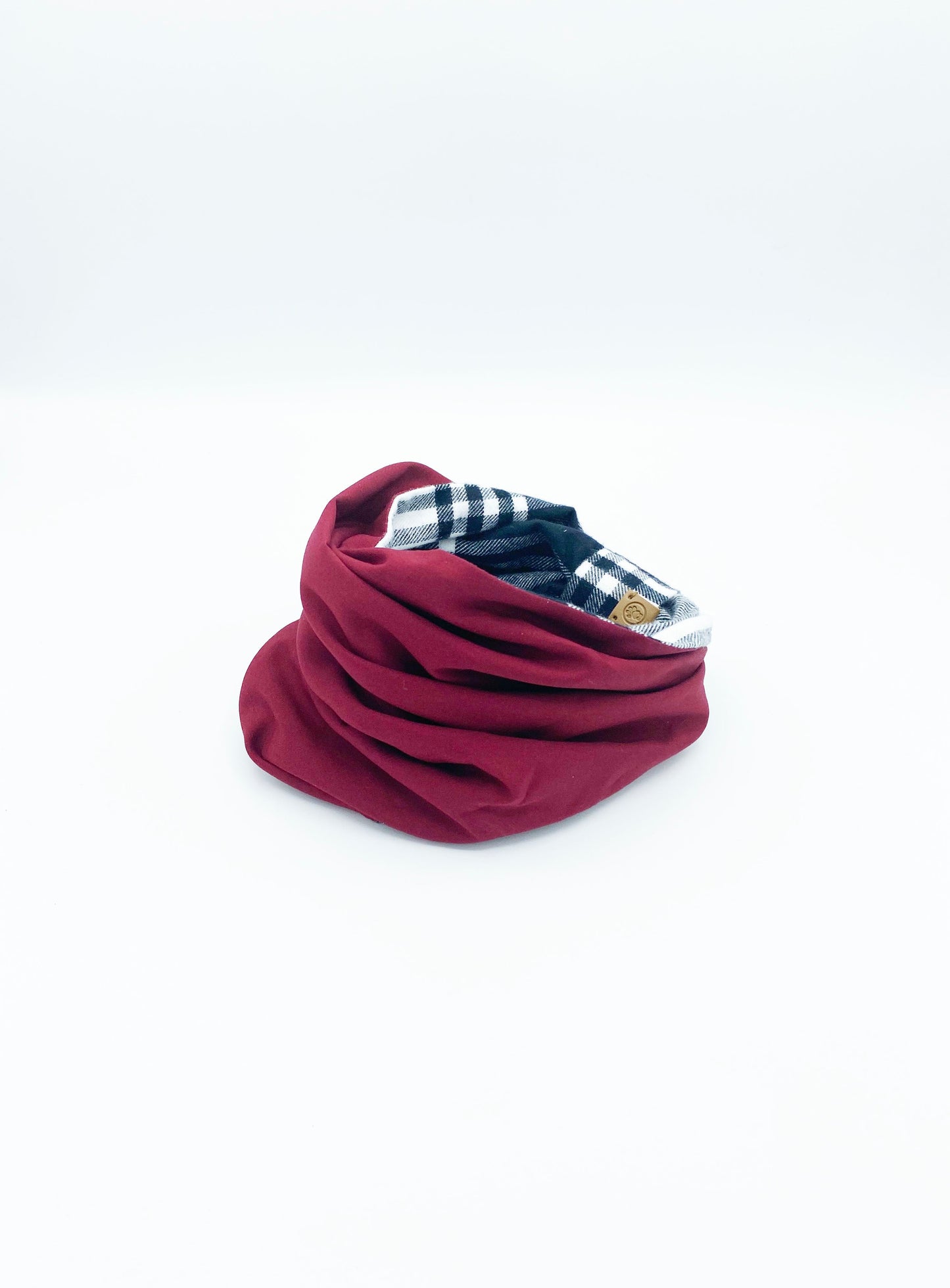 Red neck gaiter with plaid pattern on a white background