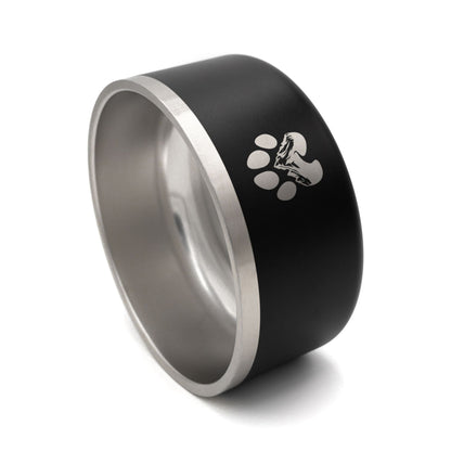 Black and silver ring with a paw print design on a white background