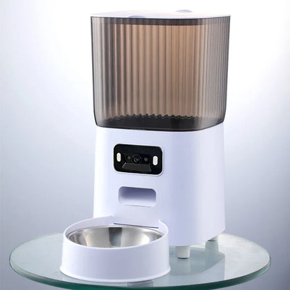 White pet feeder with transparent brown top on a clear glass surface