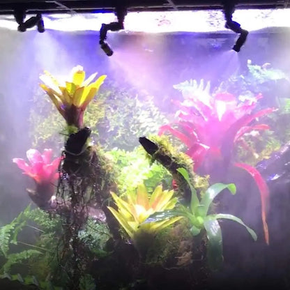 Artificial plants in an aquarium setting with colorful lights.