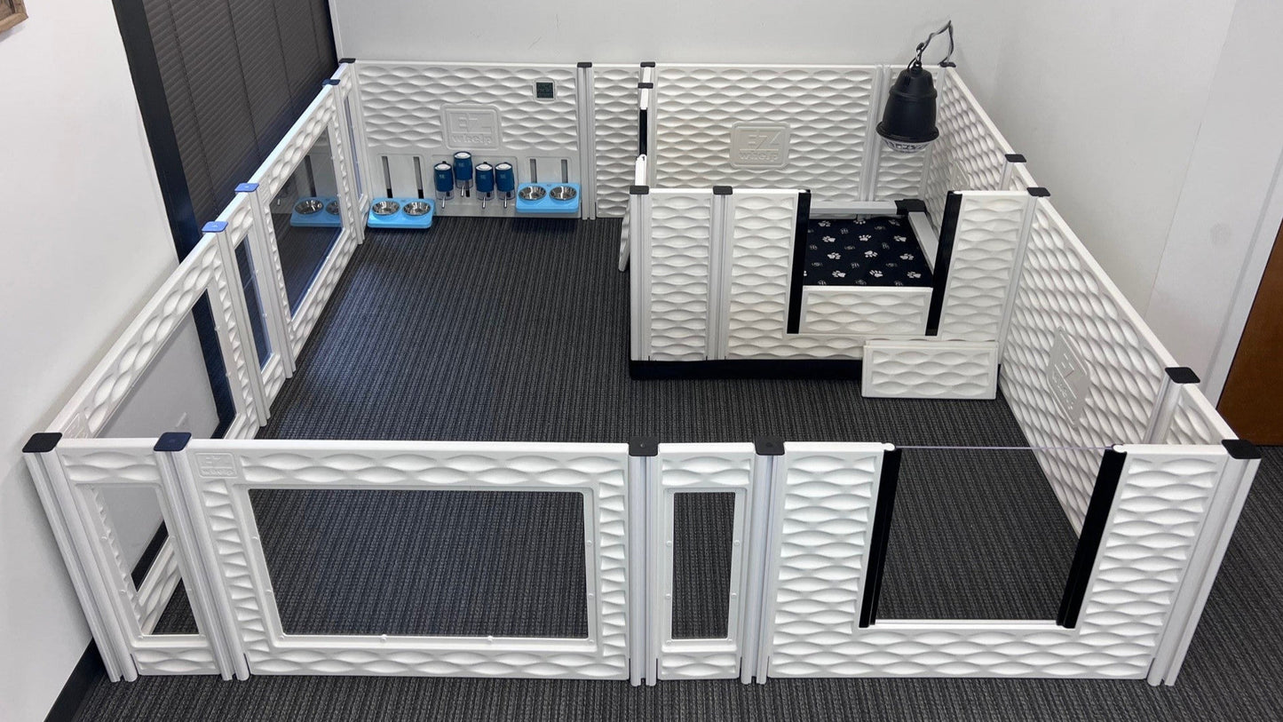 Pet playpen with various toys and items inside on a black floor.