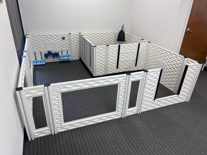 Pet playpen with multiple sections and accessories on a gray floor.