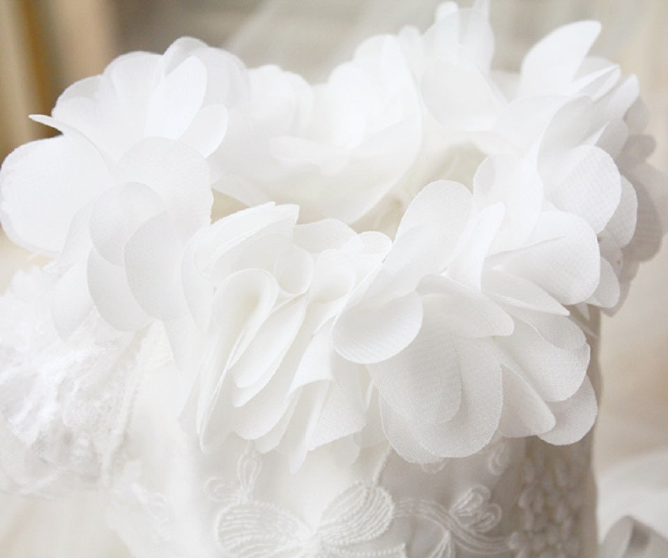 Close-up of a white floral headband with lace details.