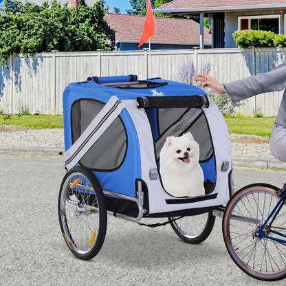Blue and white pet bike trailer with a dog inside, attached to a bicycle on a residential street.