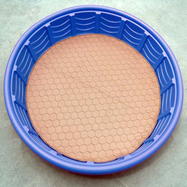 Round beige mat with honeycomb pattern inside a blue circular frame on a light gray background