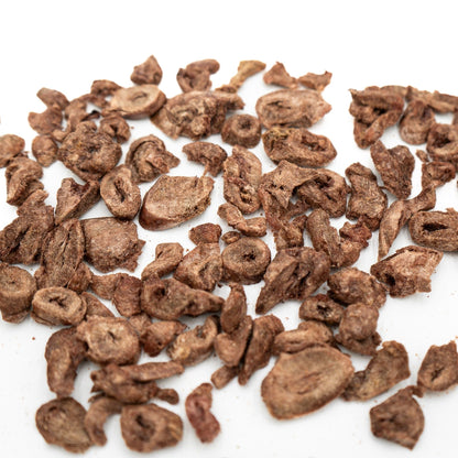 Brown dried fruits or nuts on a white background