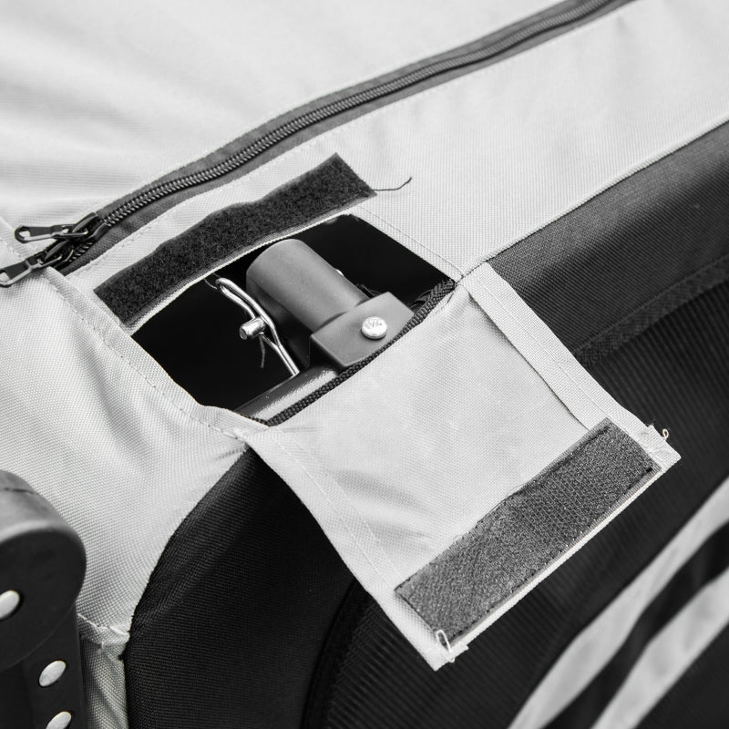 Close-up of a backpack with a zipper pocket and strap attachment.