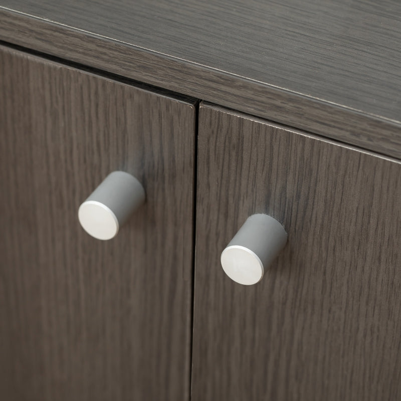 Close-up of a wooden cabinet with gray knobs