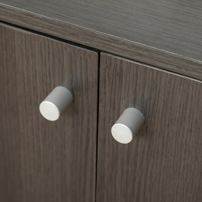 Close-up of a wooden cabinet with gray knobs