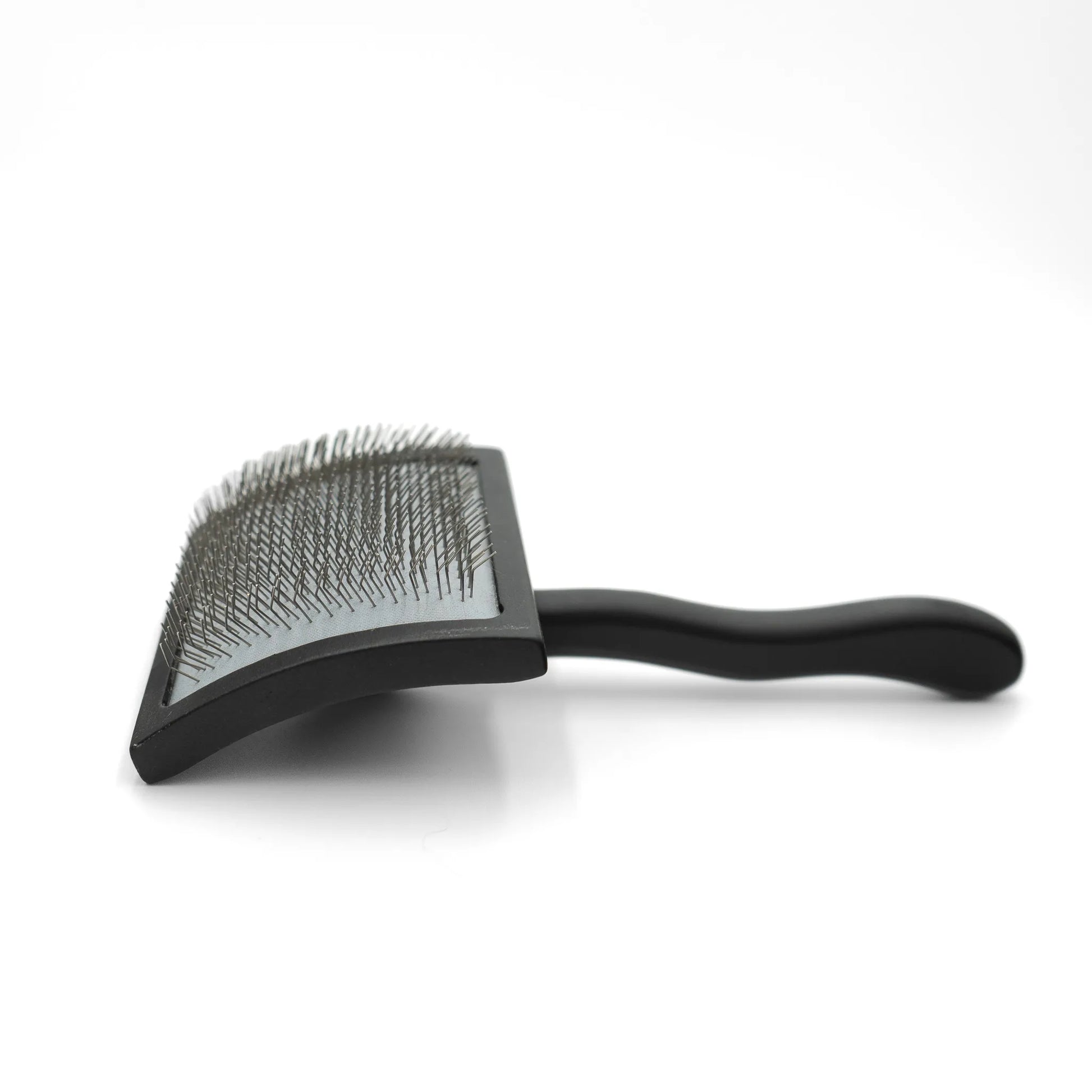 Black pet grooming brush on a white background