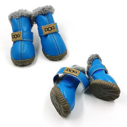 Pair of blue dog boots with gray fur lining on a white background