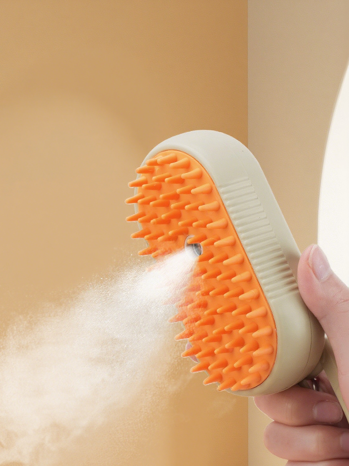 Hand holding a beige and orange scrubber with soap suds on a beige background