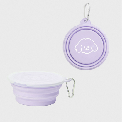Collapsible purple silicone travel bowl with lid and carabiner on a white background