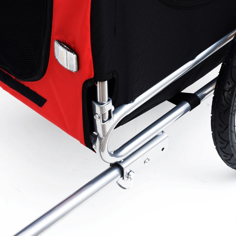 Close-up of a red and black wheelchair with a silver brace on a white background