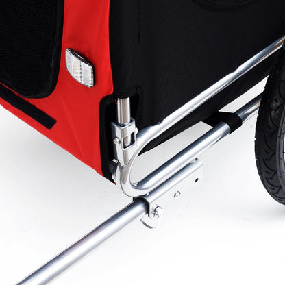 Close-up of a red and black wheelchair with a silver brace on a white background