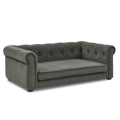 Gray sofa with tufted backrest on a white background