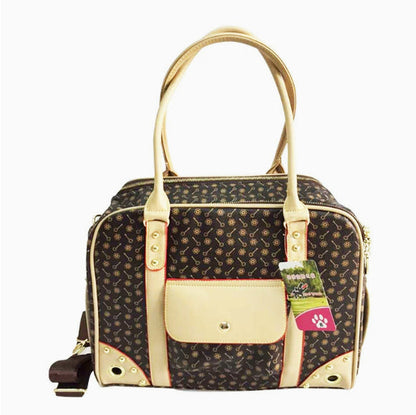 Dog carrier with gold accents on a white background