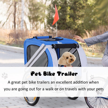 Pet bike trailer with a dog inside, being pushed by a person on a path.