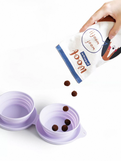 Collapsible purple pet water bowl with a hand pouring treats from a branded bag.