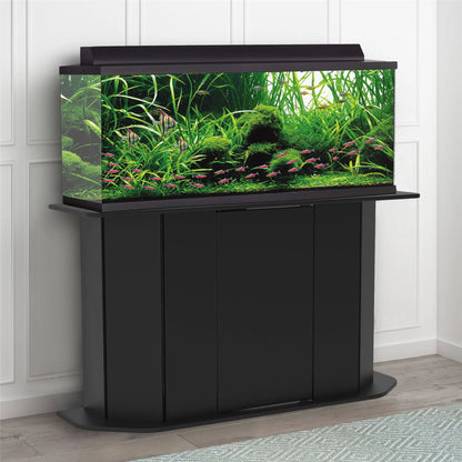 Black aquarium stand with a fish tank filled with water plants and fish on a white paneled wall background.