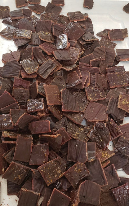 Close-up of dark chocolate pieces on a white surface