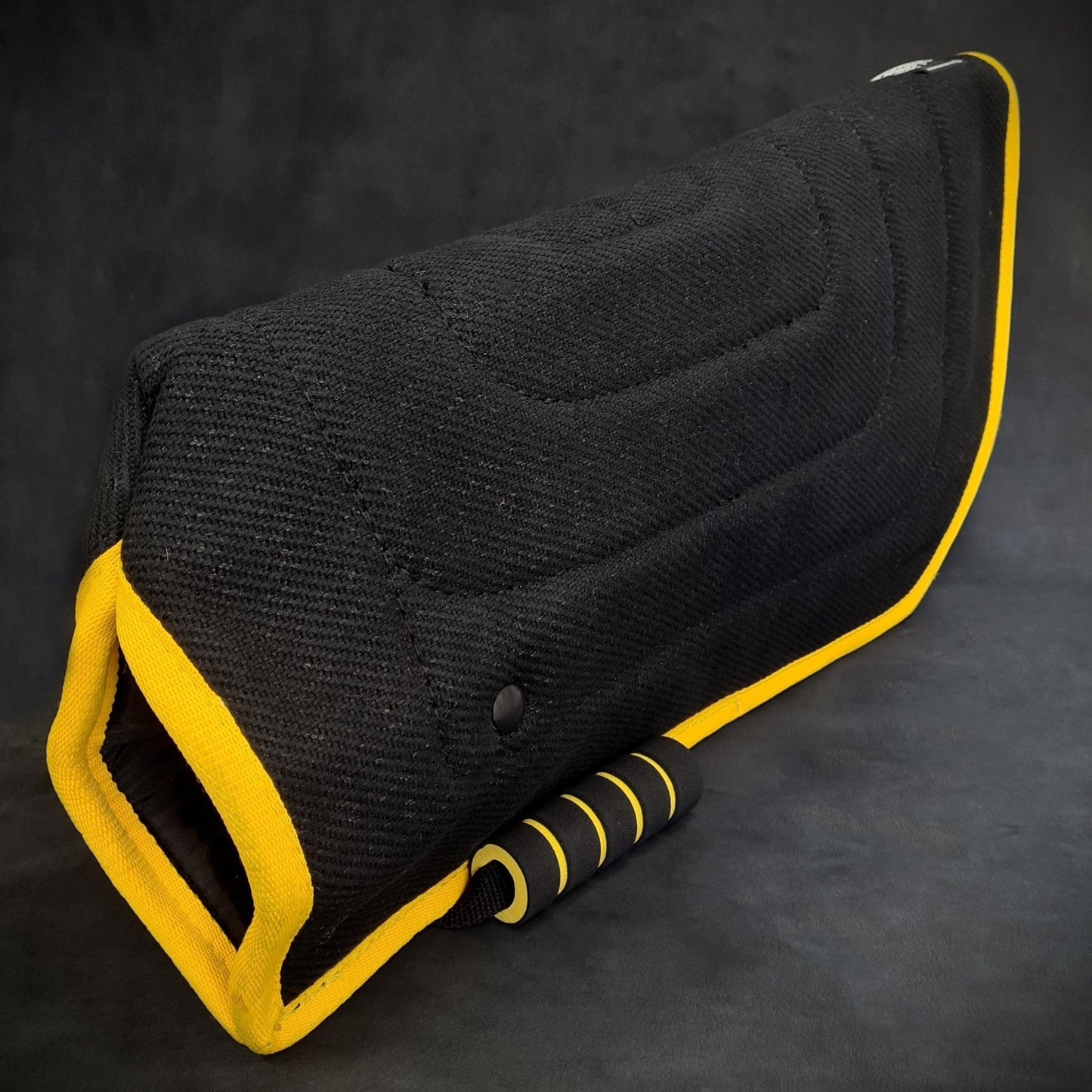 Black and yellow car seat cover on a dark background