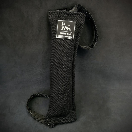 Black dog leash with a brand label on a dark background