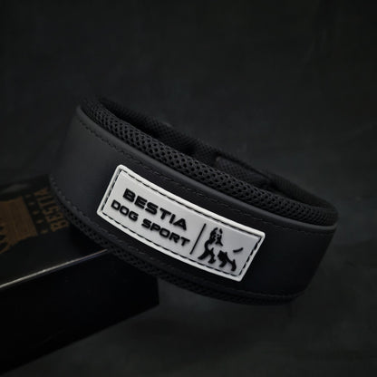 Black dog collar with 'Bestia Dog Sport' label on a dark background