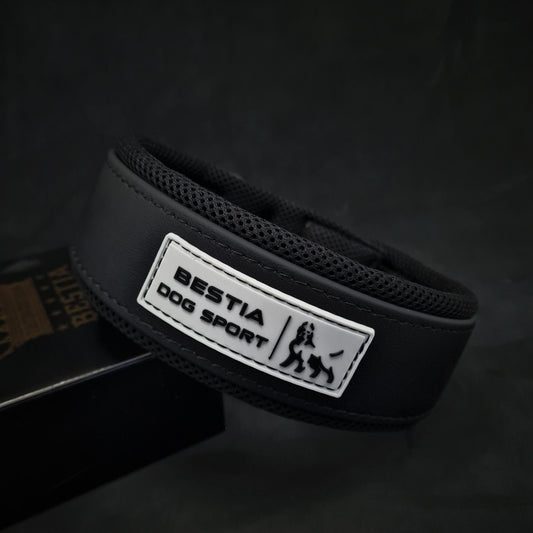 Black dog collar with 'Bestia Dog Sport' label on a dark background