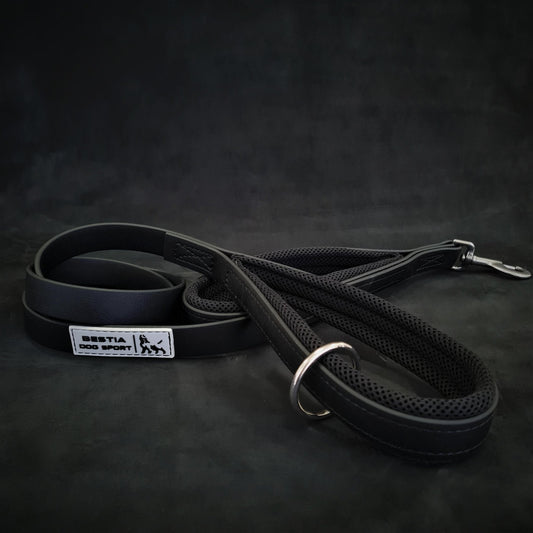 Black dog leash with a metal clip on a dark background