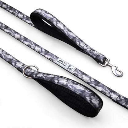 Dog leash with floral pattern and black handle on a white background