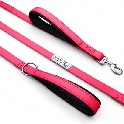 Pink dog leash with black handle on a white background