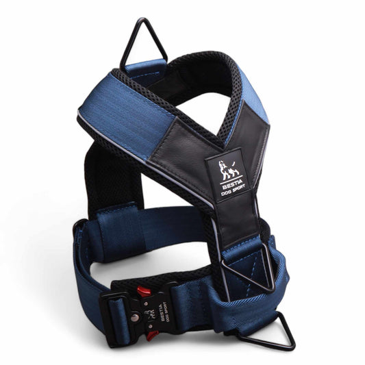 Blue and black dog harness with a visible brand logo on a white background