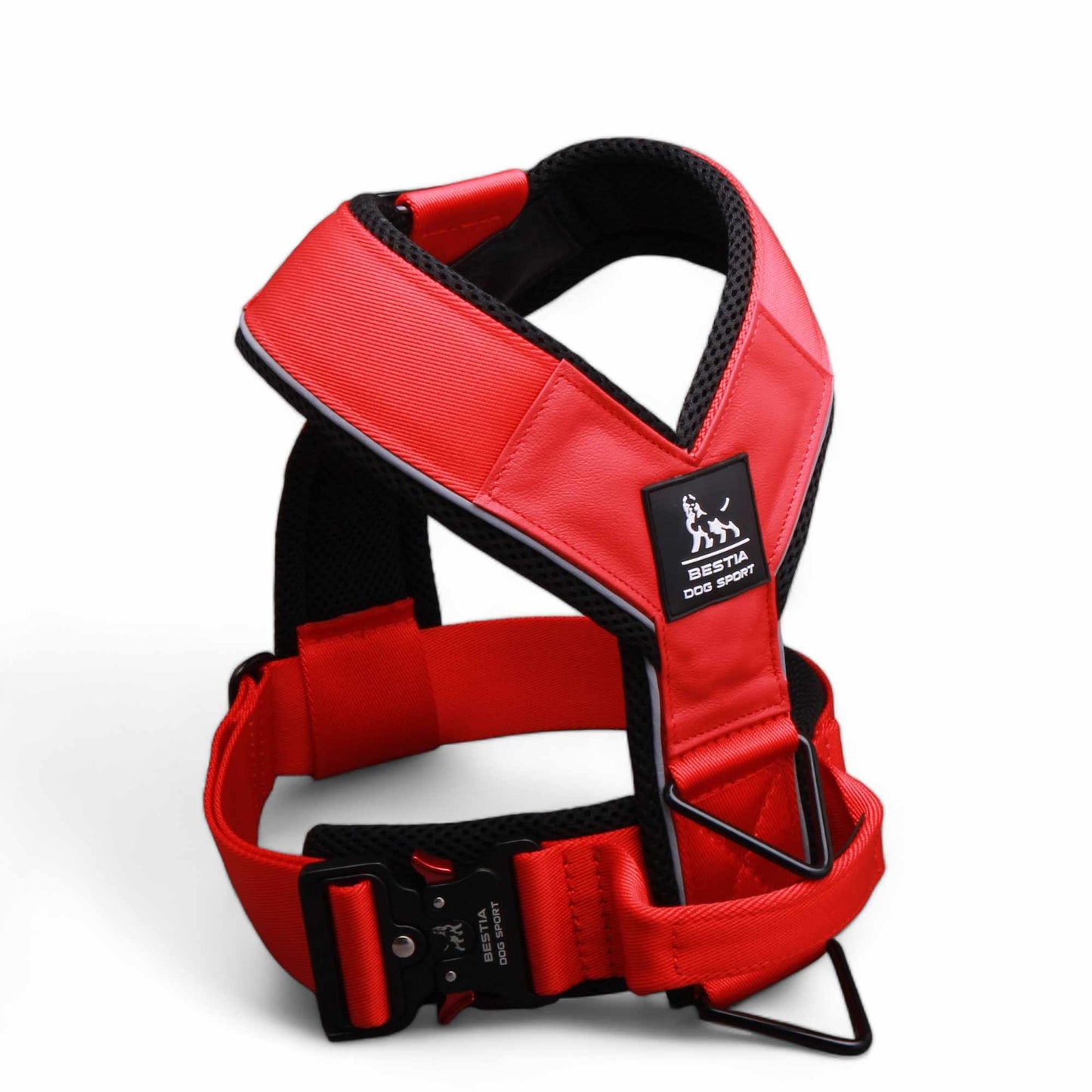 Red dog harness with black straps on a white background