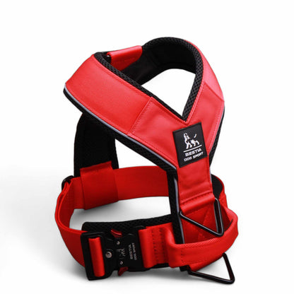 Red dog harness with black straps on a white background