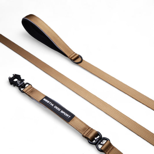 Beige dog leash with black clip and 'Bestia Dog Sport' label on a white background