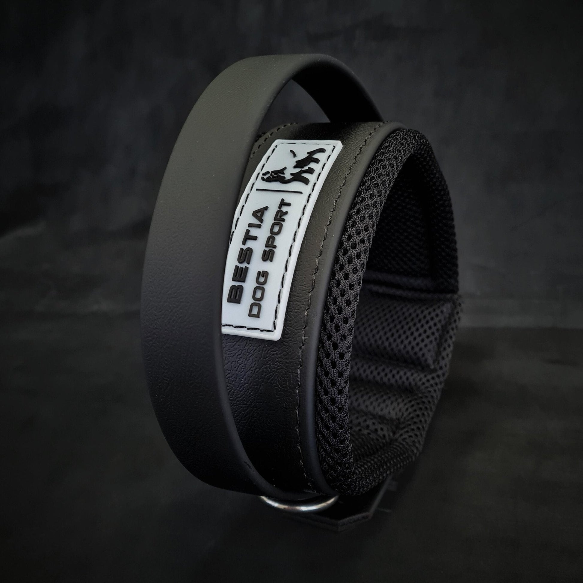 Black dog collar with a visible brand label on a dark background