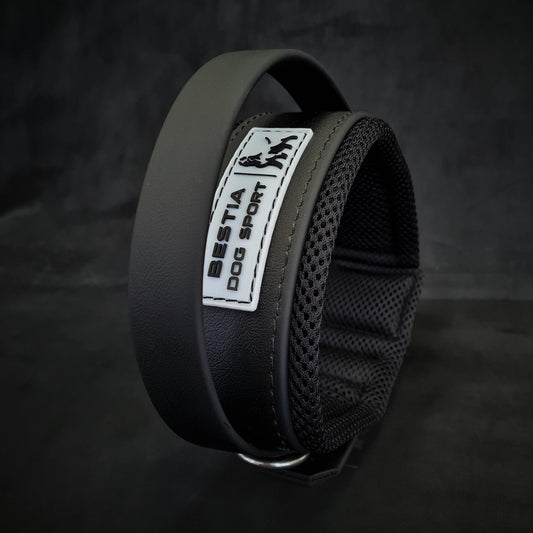 Black dog collar with a visible brand label on a dark background
