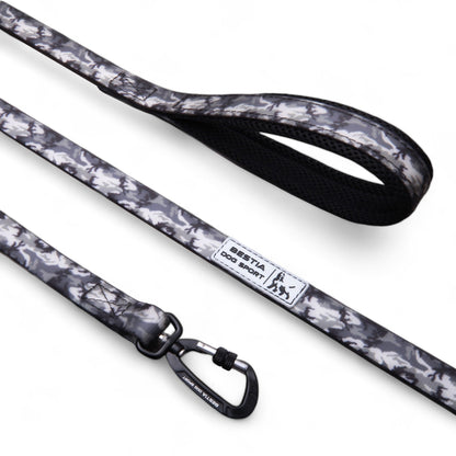 Dog leash with camouflage pattern and brand label on a white background