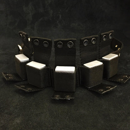 Black tactical belt with multiple pouches on a dark background