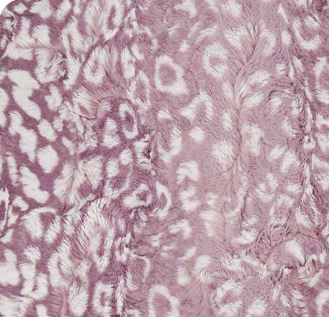 Close-up of a textured pink fabric with a subtle pattern