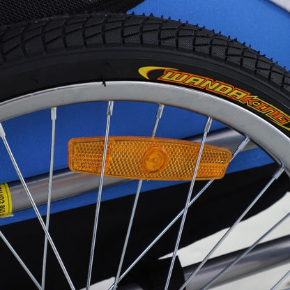 Close-up of a bicycle wheel with a yellow reflector and 'Wanda King' branding on a blue background.