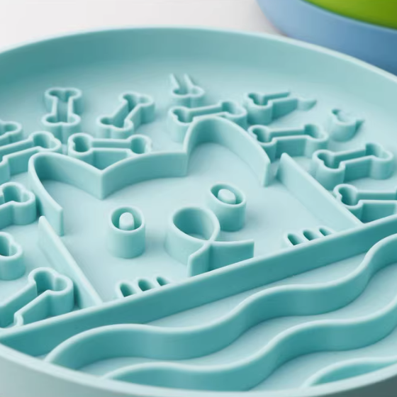 Close-up of a blue silicone mold with various shapes on a white background