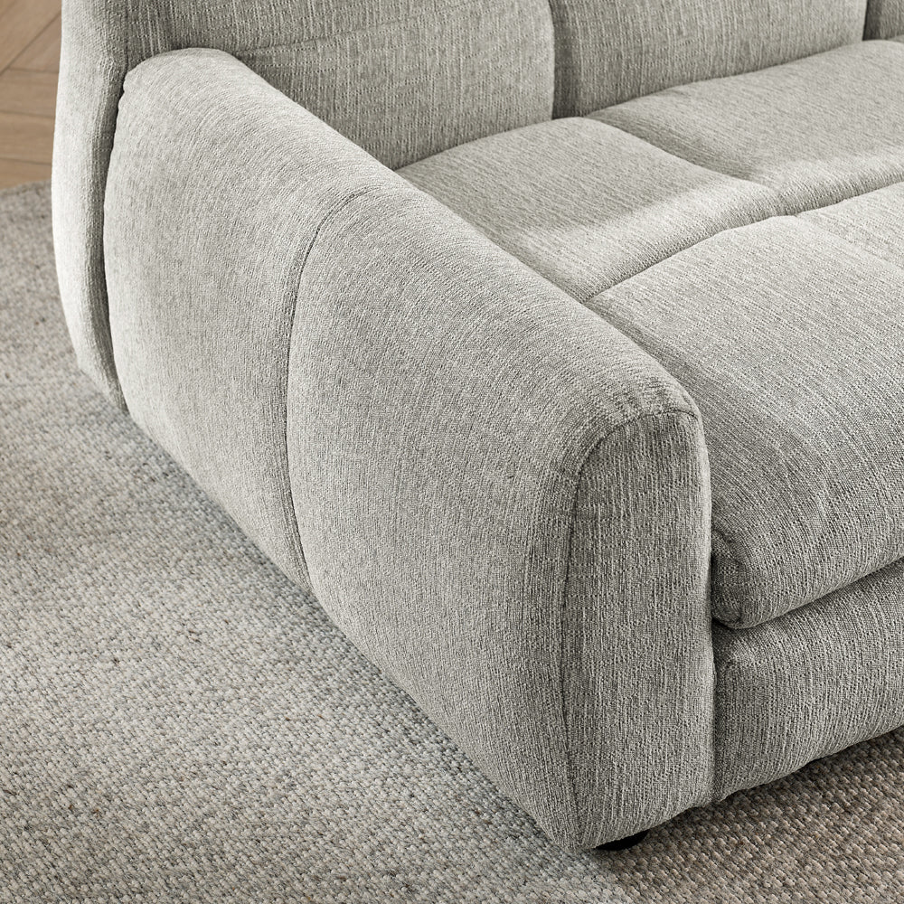 Gray upholstered sofa on a textured floor