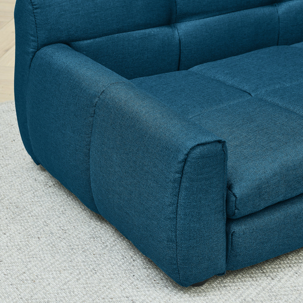 Blue fabric sofa on a light gray carpet