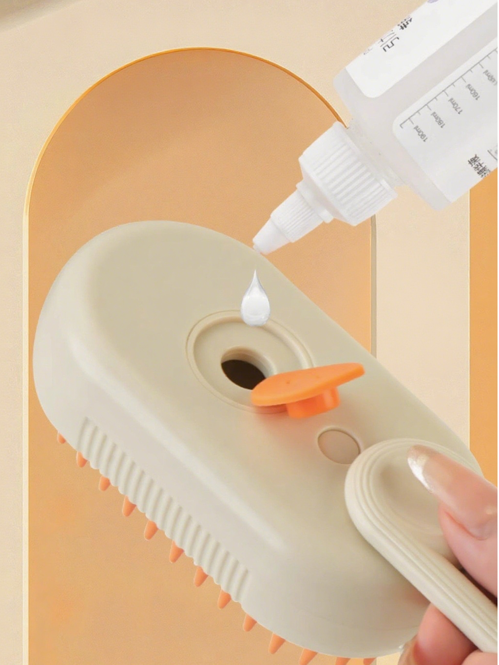 Person applying a white substance from a bottle onto a beige device with an orange button on a peach-colored background.