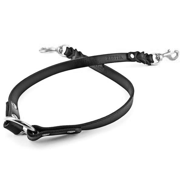 Black leather dog collar with metal hardware on a white background